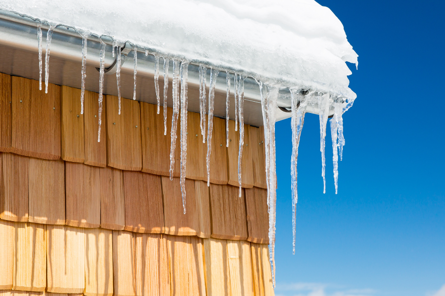Ice dam formation on DFW home gutters during winter freeze