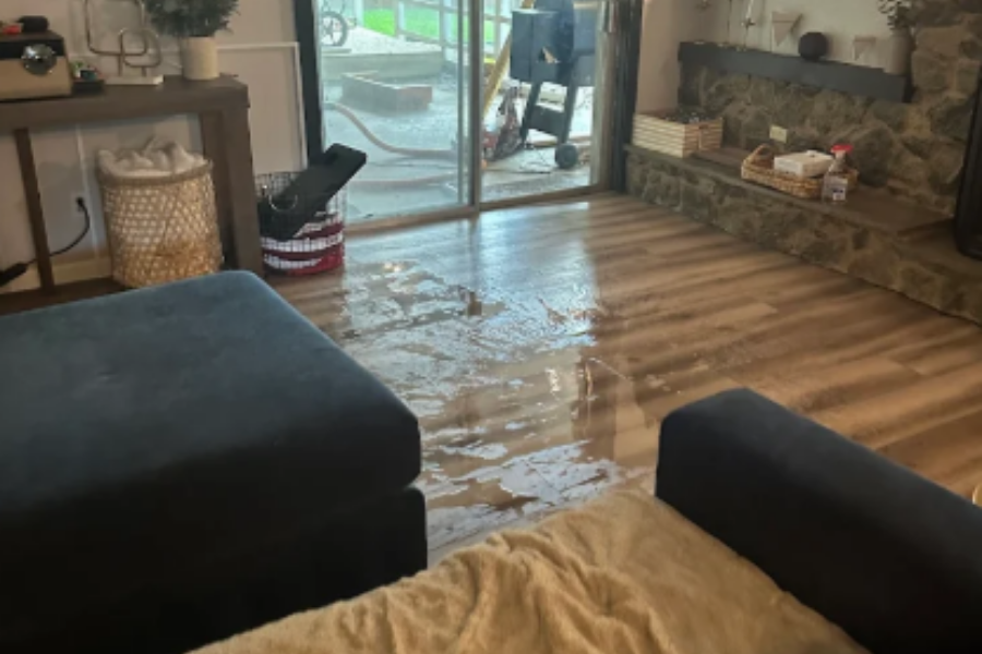 Standing water in a living room showing flood damage