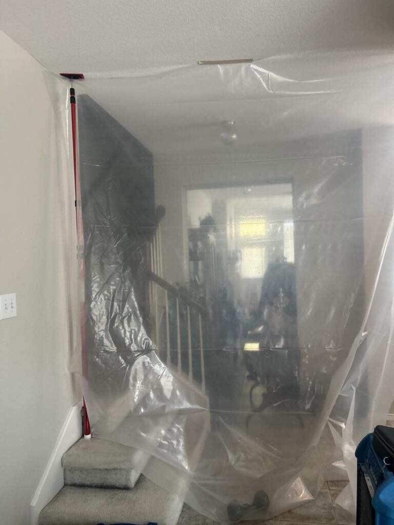 Plastic containment and drying equipment set up during water damage restoration