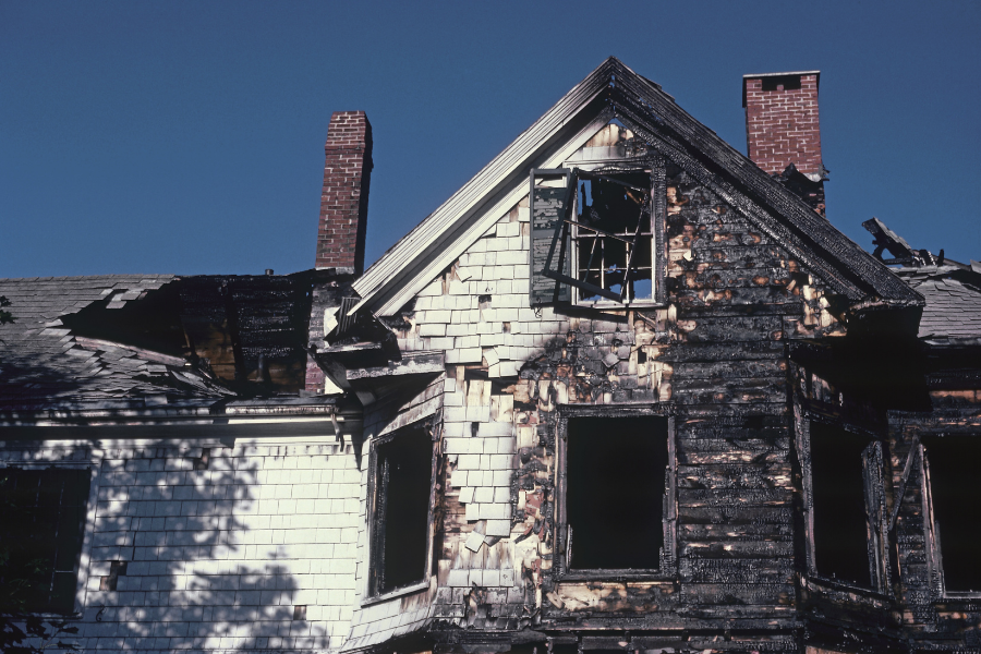 Fire damage to residential property showing structural damage and smoke residue