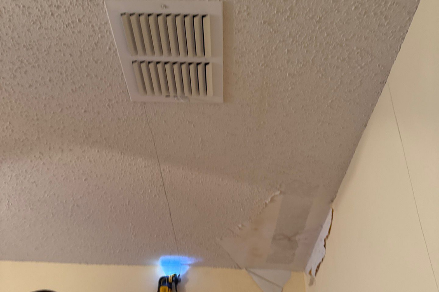 Ceiling paint peeling and bubbling from water damage