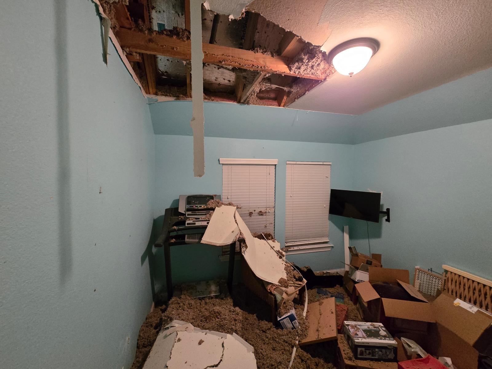 Bedroom ceiling showing water staining from attic pipe leak