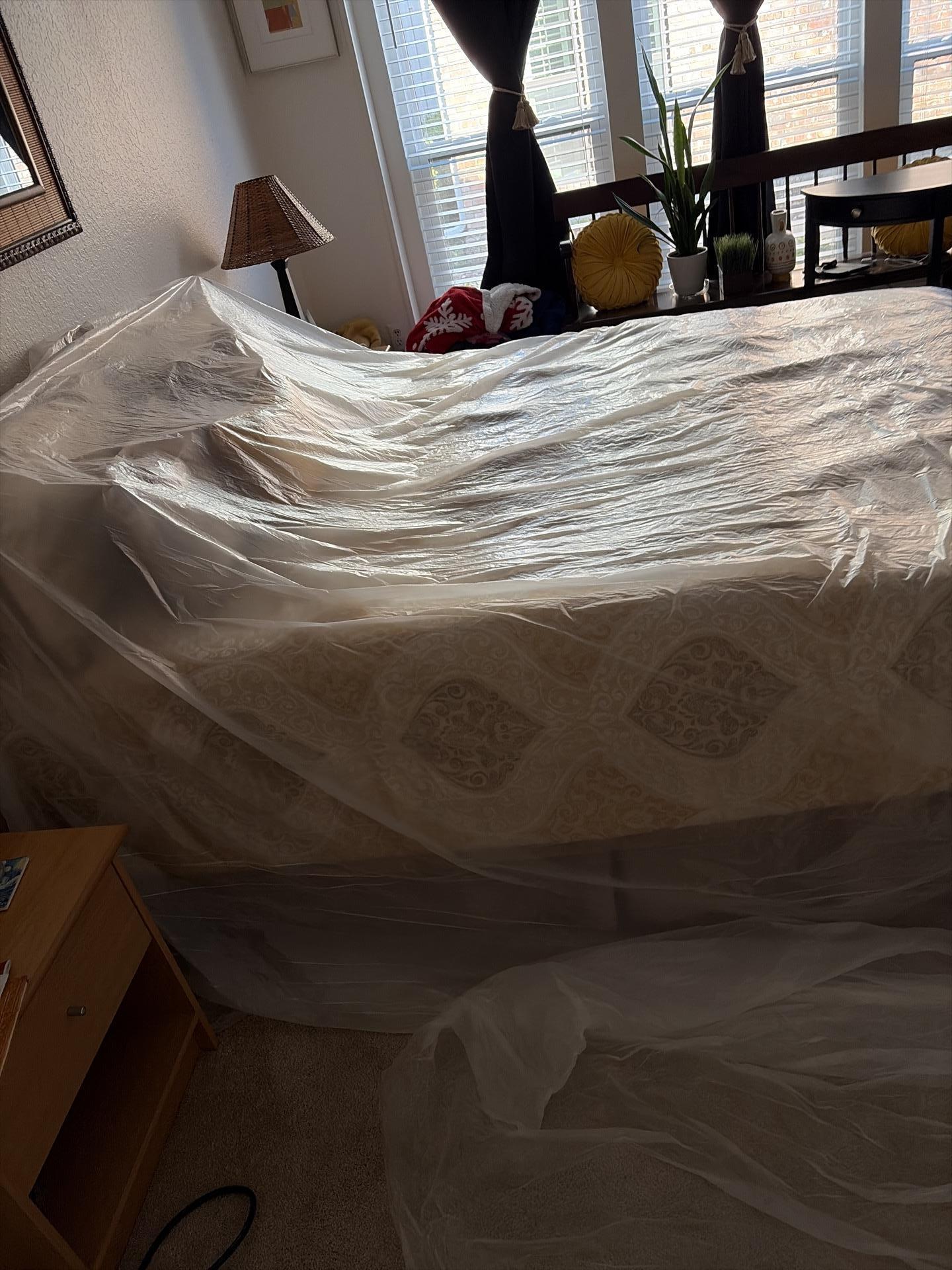 Plastic sheeting protecting bedroom during restoration