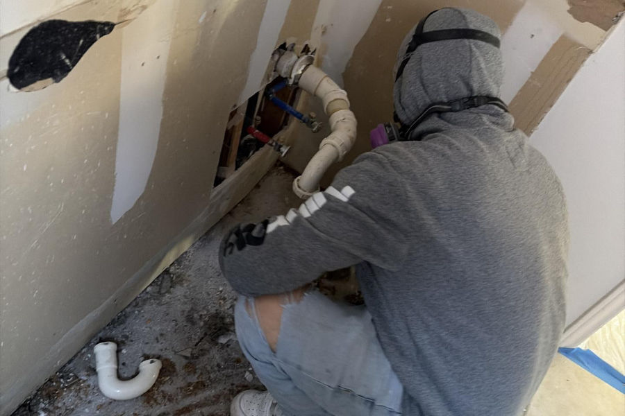 Demolition work during professional bathroom water damage restoration