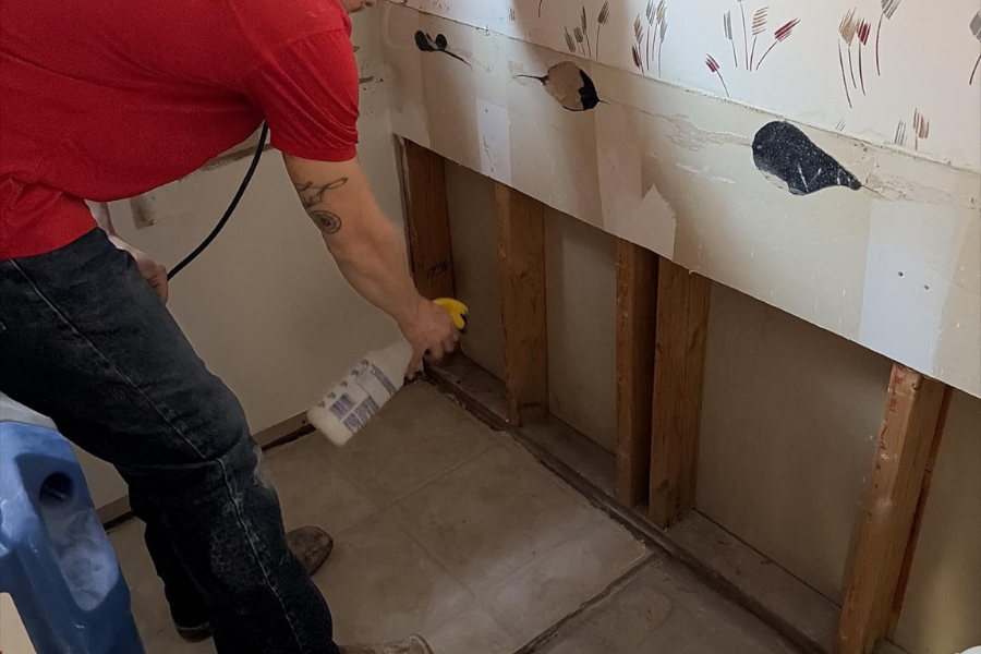 Bathroom restoration work showing sanitization after drywall demo