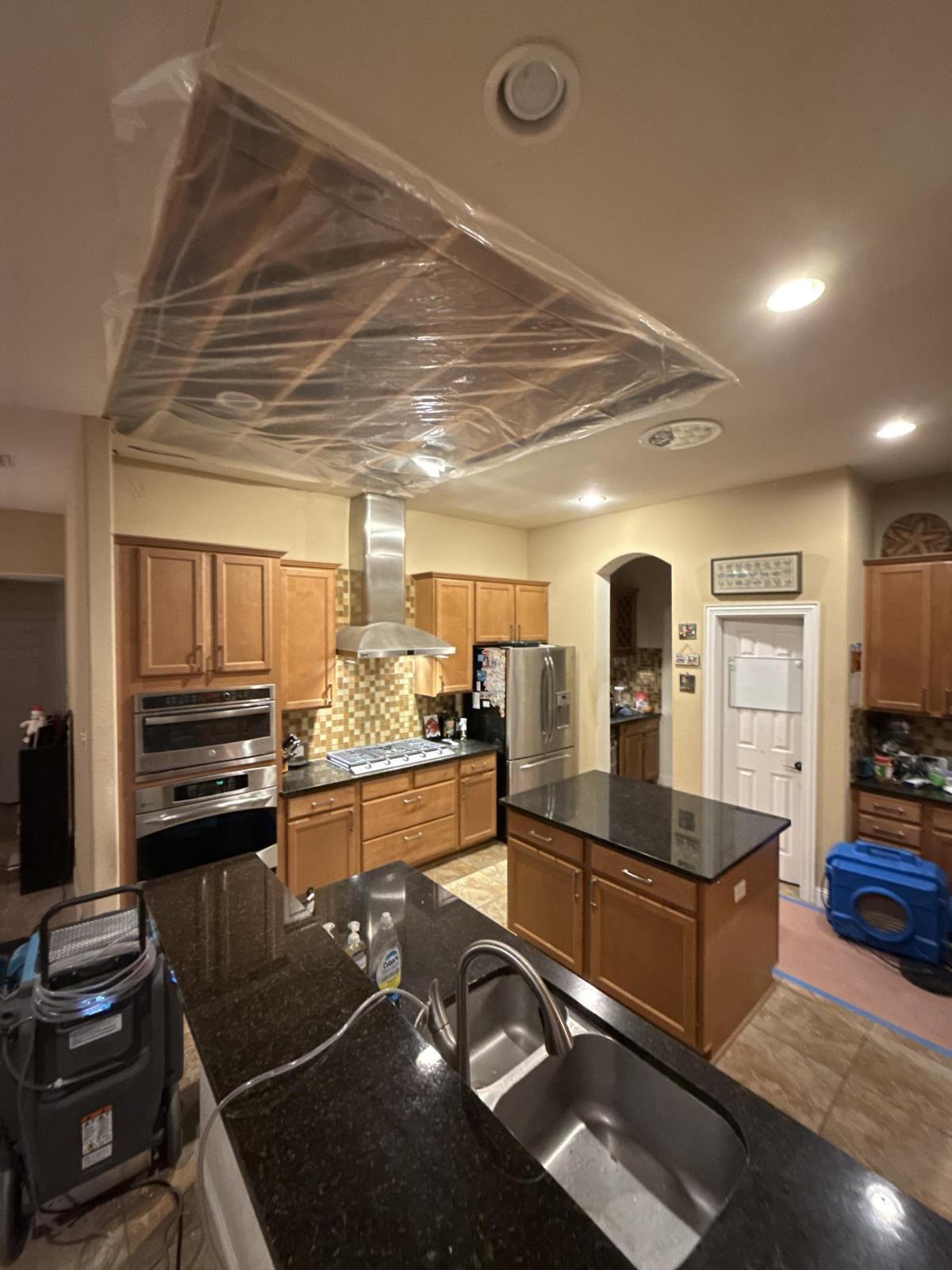 Water damage visible on kitchen ceiling from attic leak