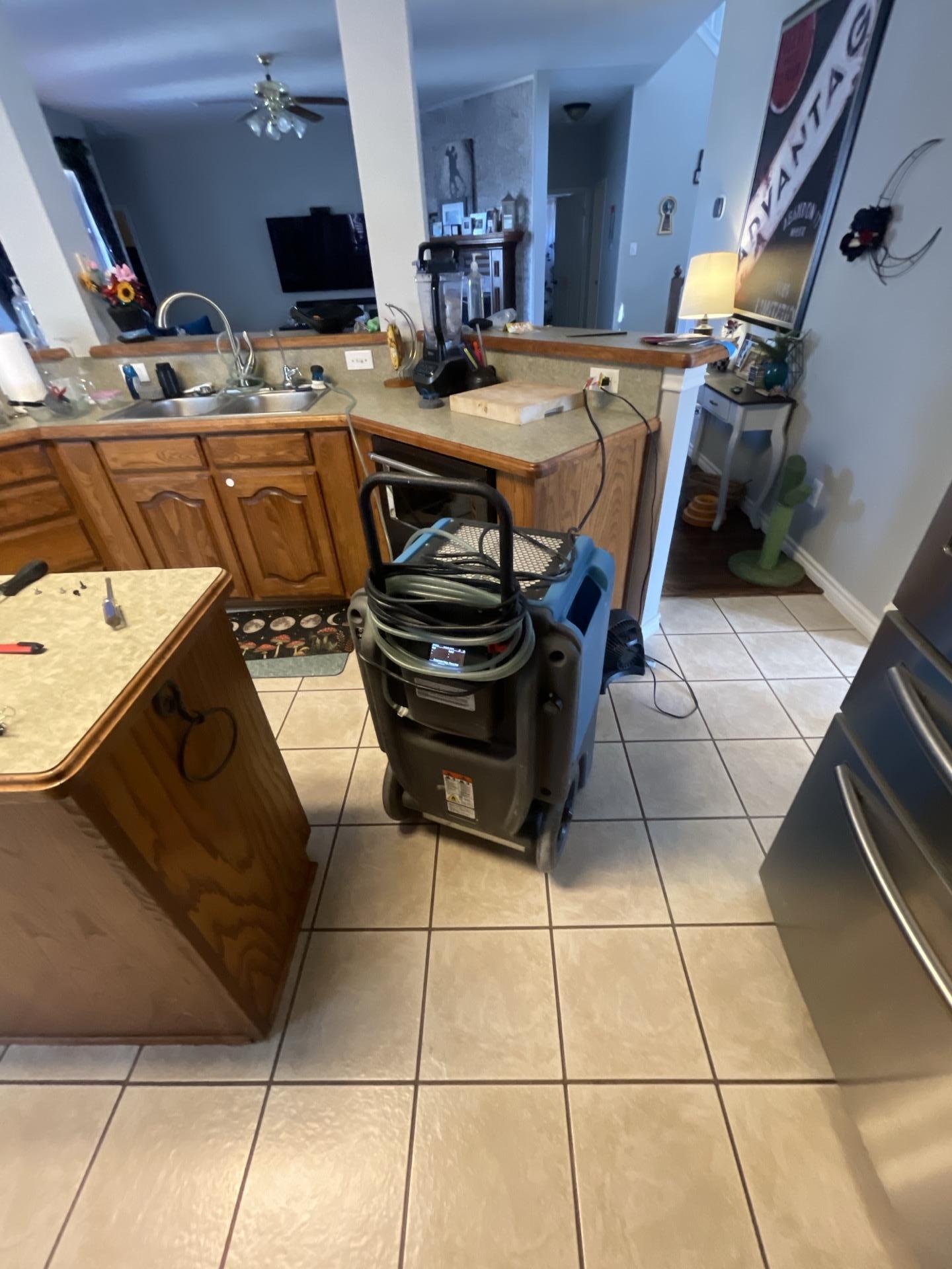 Commercial drying equipment running in kitchen after dishwasher water damage