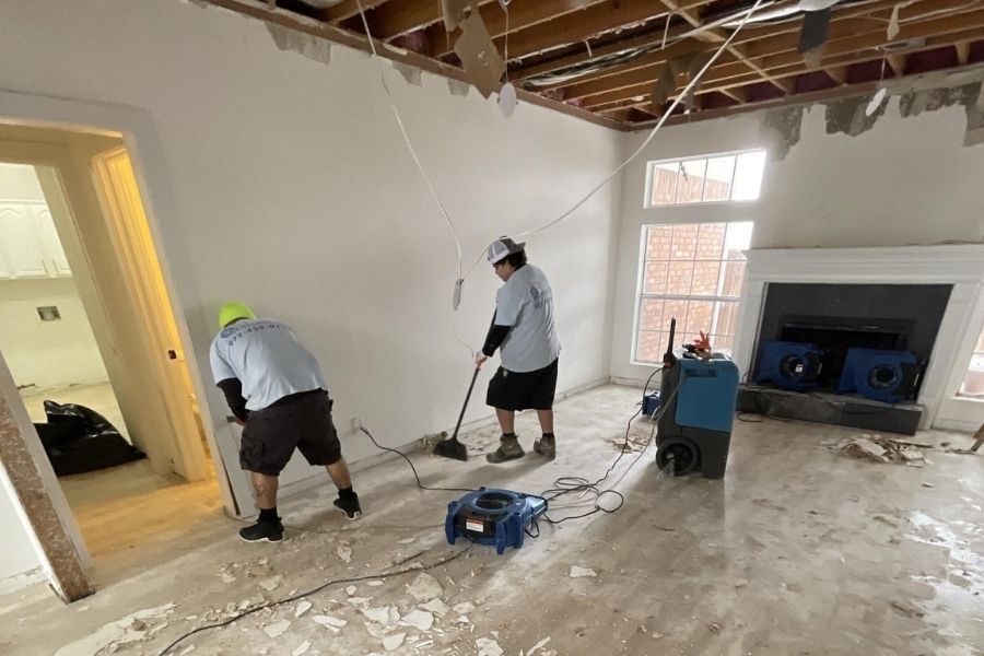 Restoration team setting up professional drying equipment on a job site