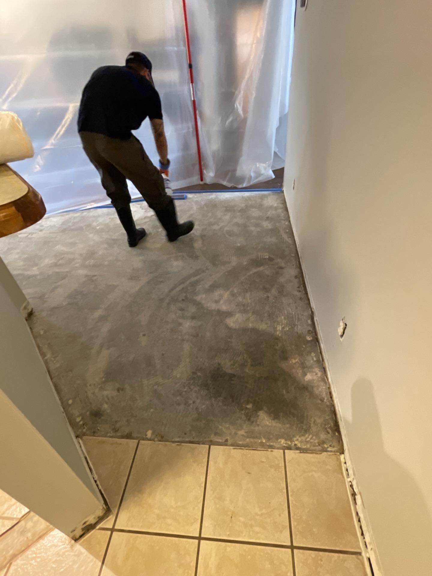 Flooring demolition and containment during dishwasher water damage restoration