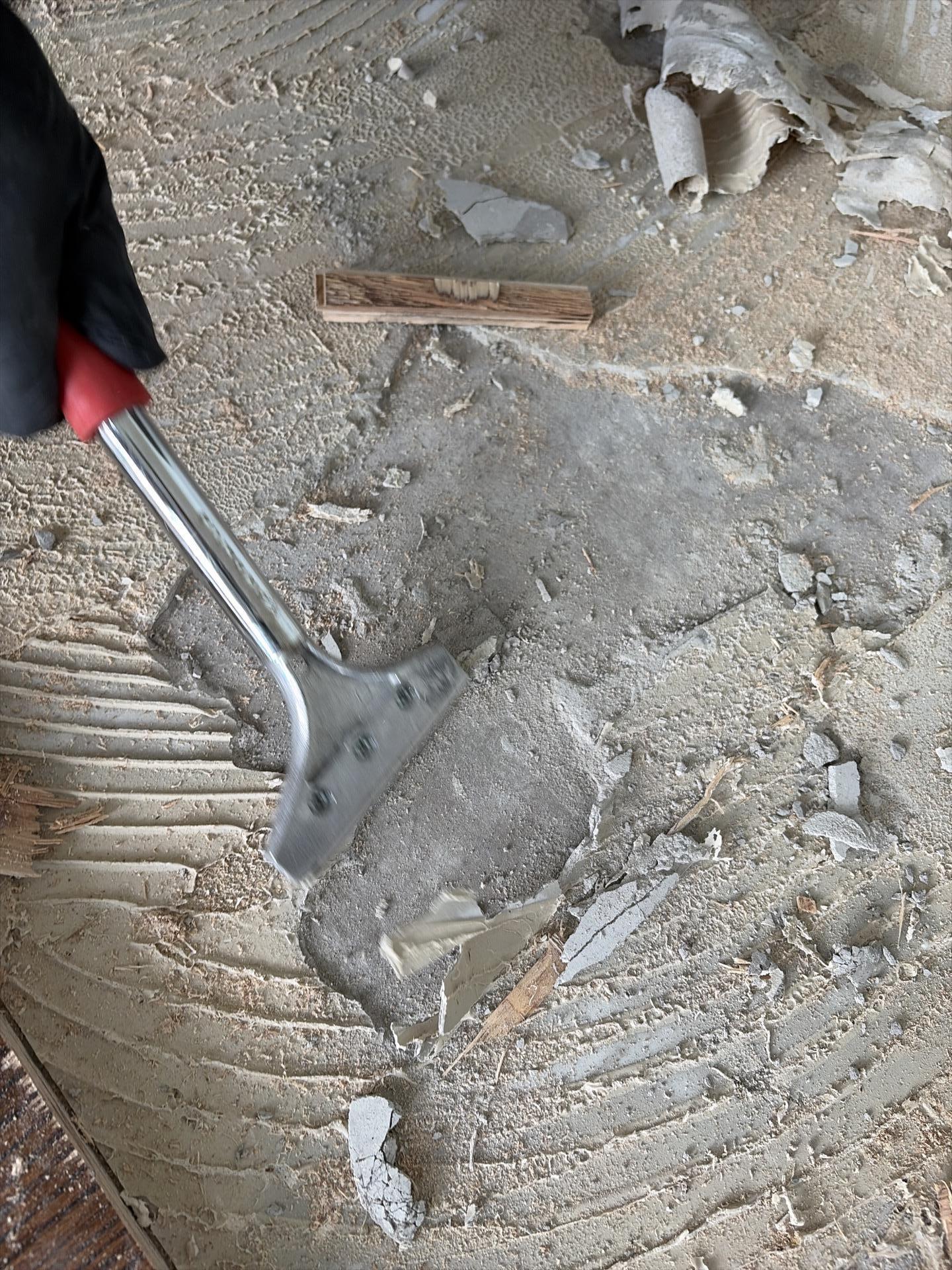 Underlayment exposed after removing water-damaged flooring