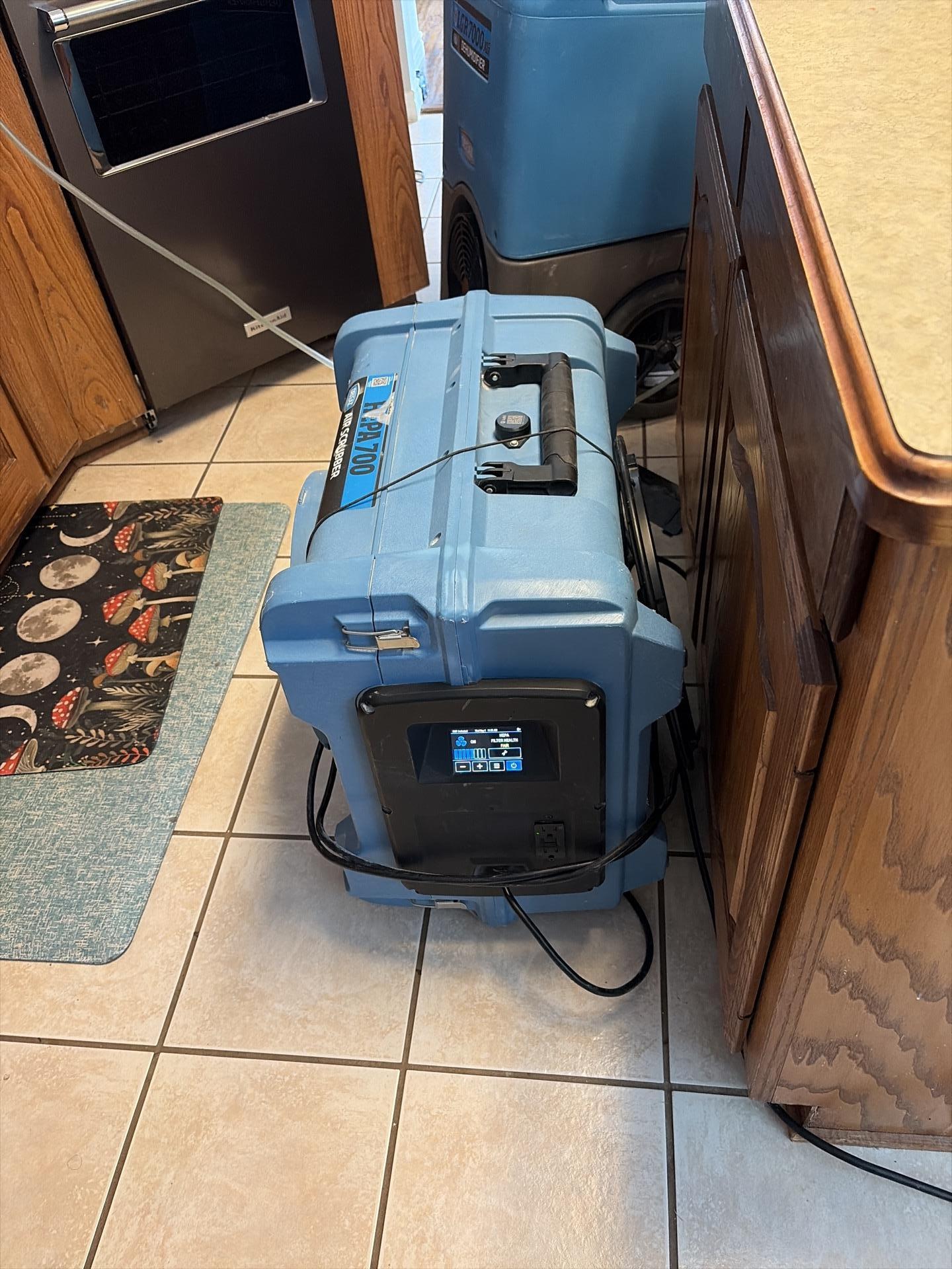 Drying equipment set up in kitchen following dishwasher water damage