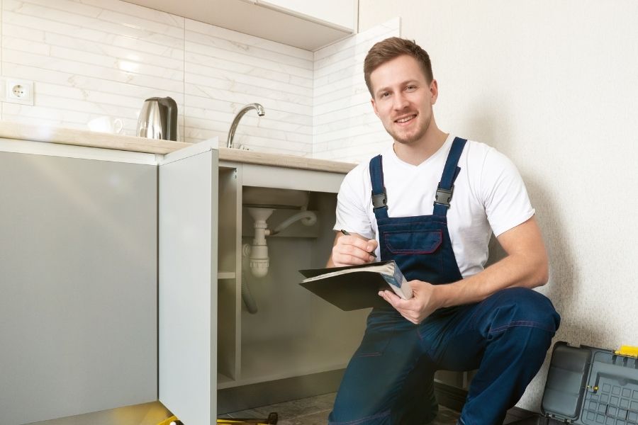 Restoration technician following a structured job checklist during a water damage assessment