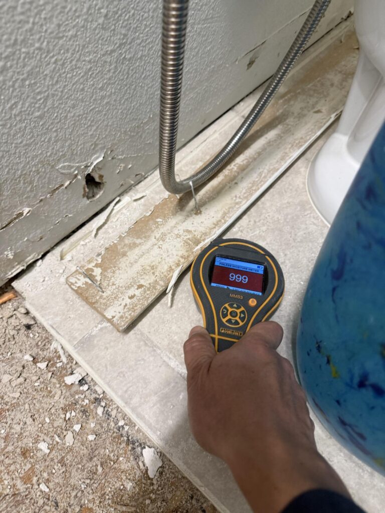 baseboards removal after supply line burst in bathroom - moisture reading after