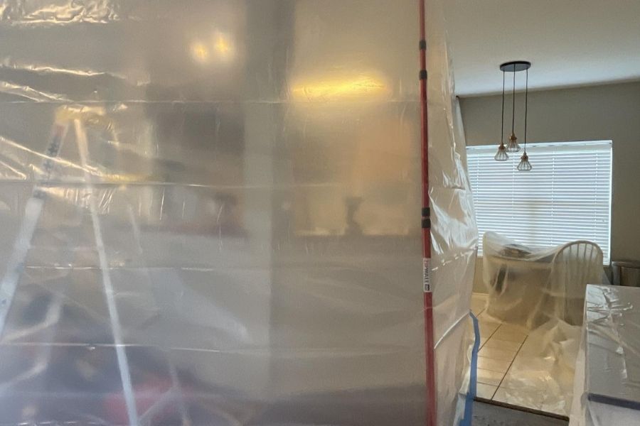 Containment chamber with plastic sheeting during professional flood cleanup
