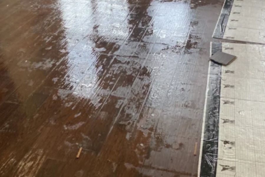 Standing water on a wooden floor after flooding