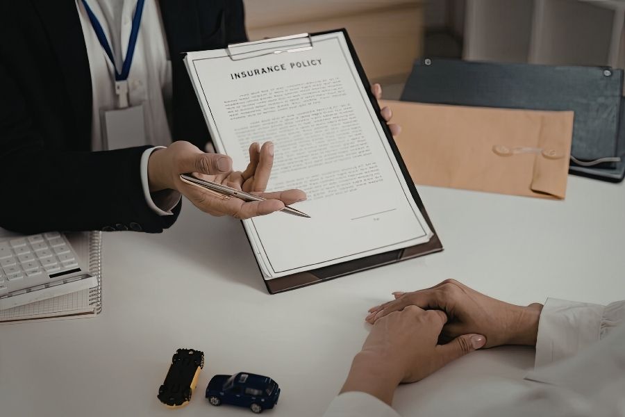 Homeowner reviewing insurance policy documents to understand water damage coverage