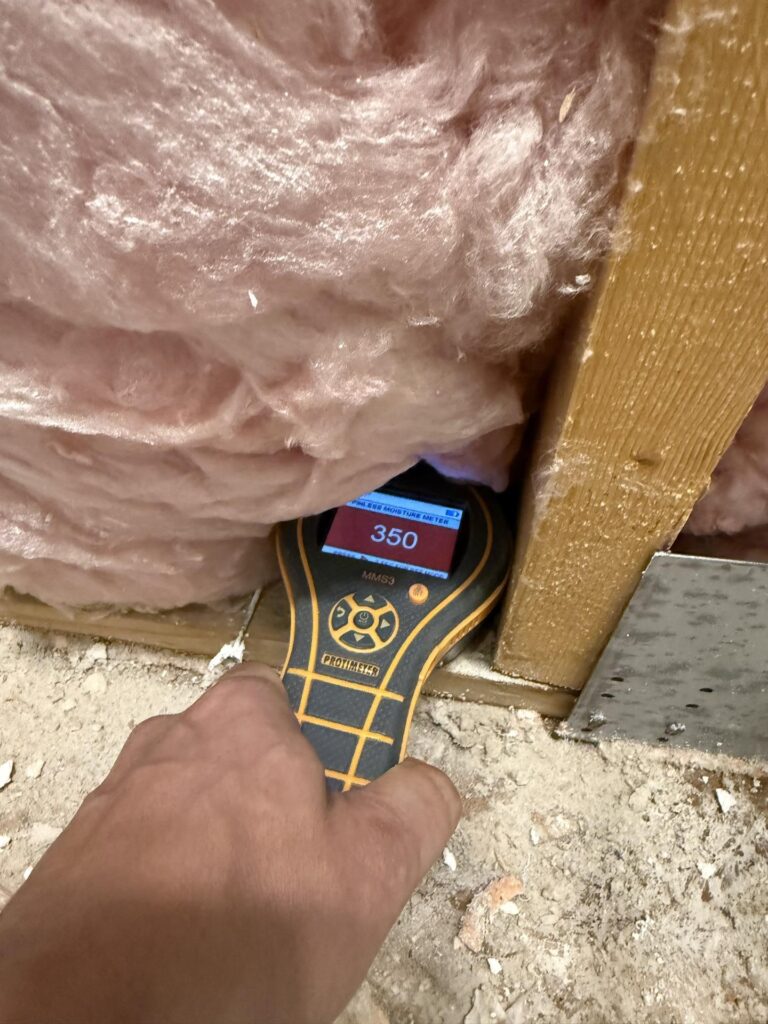 water-damaged insulation in the upstairs bathroom after supply line burst