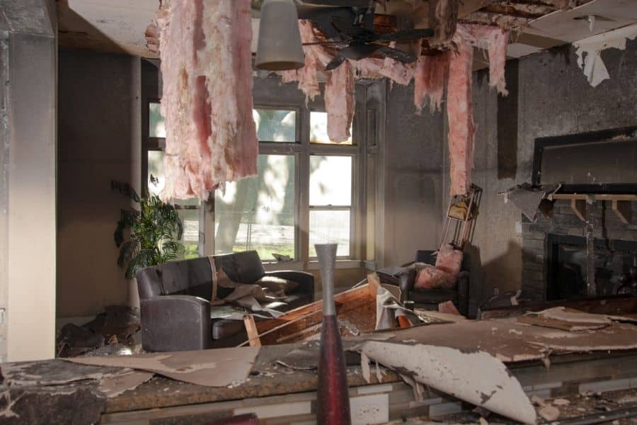 Interior ceiling and wall damage caused by fire showing soot staining and structural deterioration