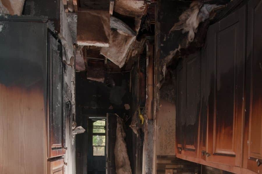 Fire-damaged kitchen showing smoke staining and burned cabinets requiring professional cleanup