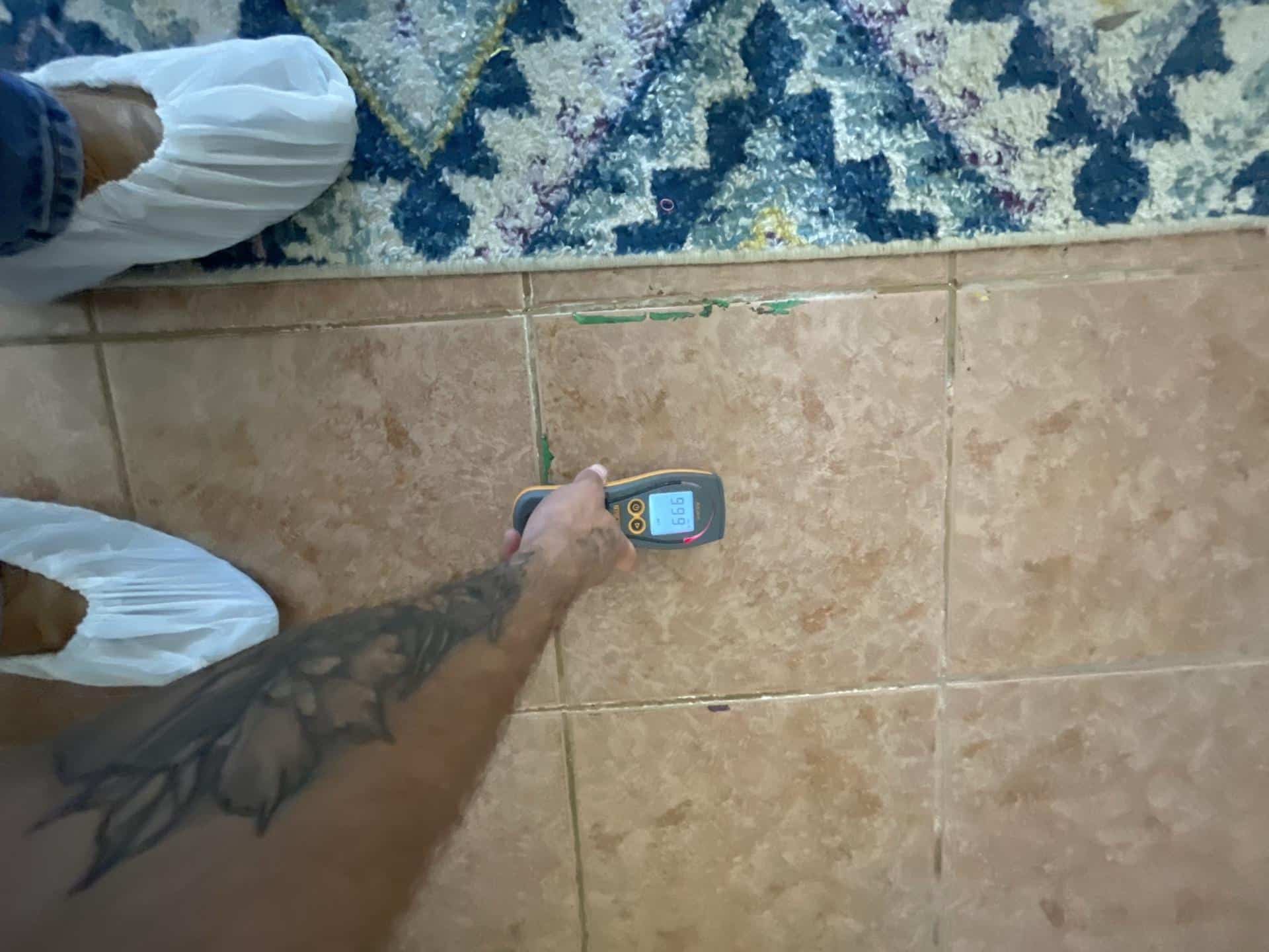 Damaged subfloor material under kitchen flooring caused by water intrusion from a sink leak