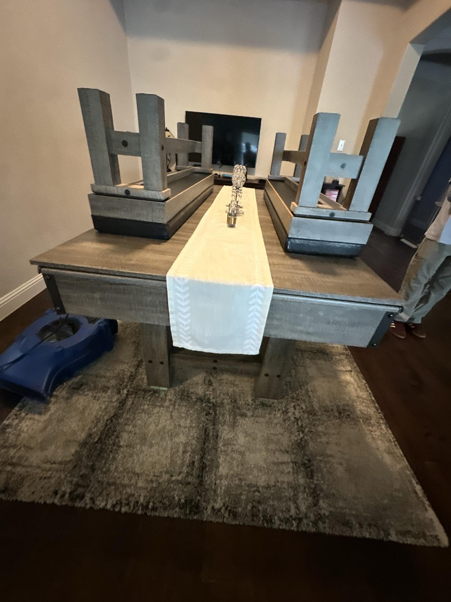 Dining room drying process with air movers positioned on hardwood floors