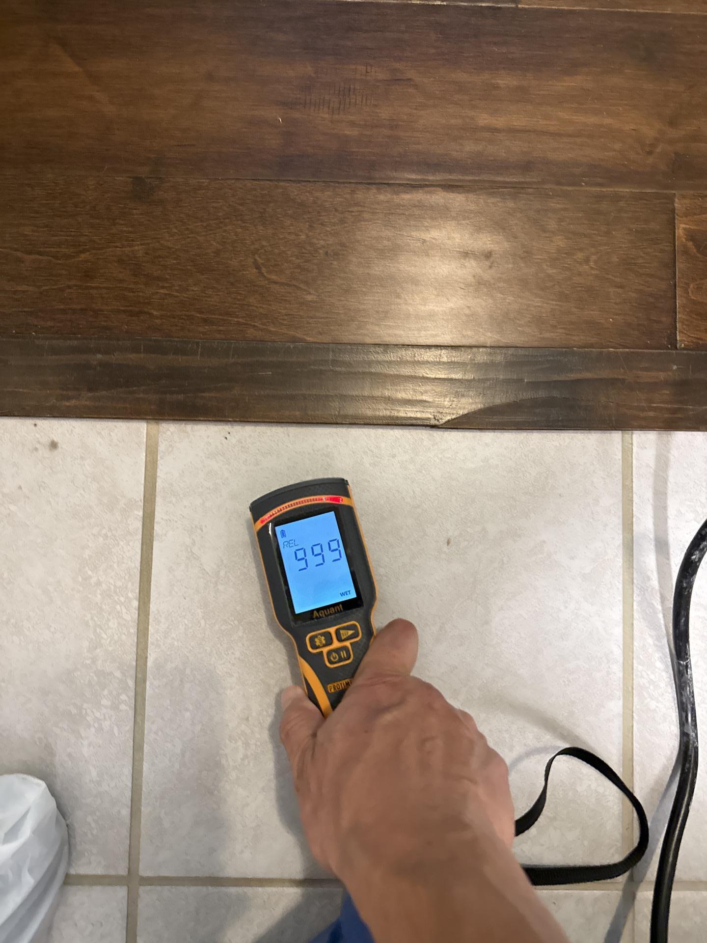 Second moisture reading confirming elevated levels near laundry room tile
