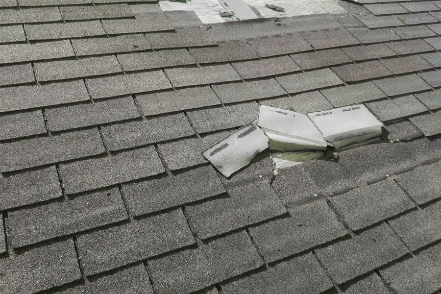 Roof shingle damage caused by summer storm winds allowing water infiltration in a Plano Texas home