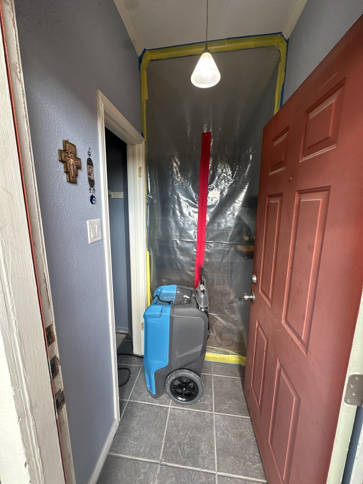 Containment barrier and drying equipment set up after water heater removal