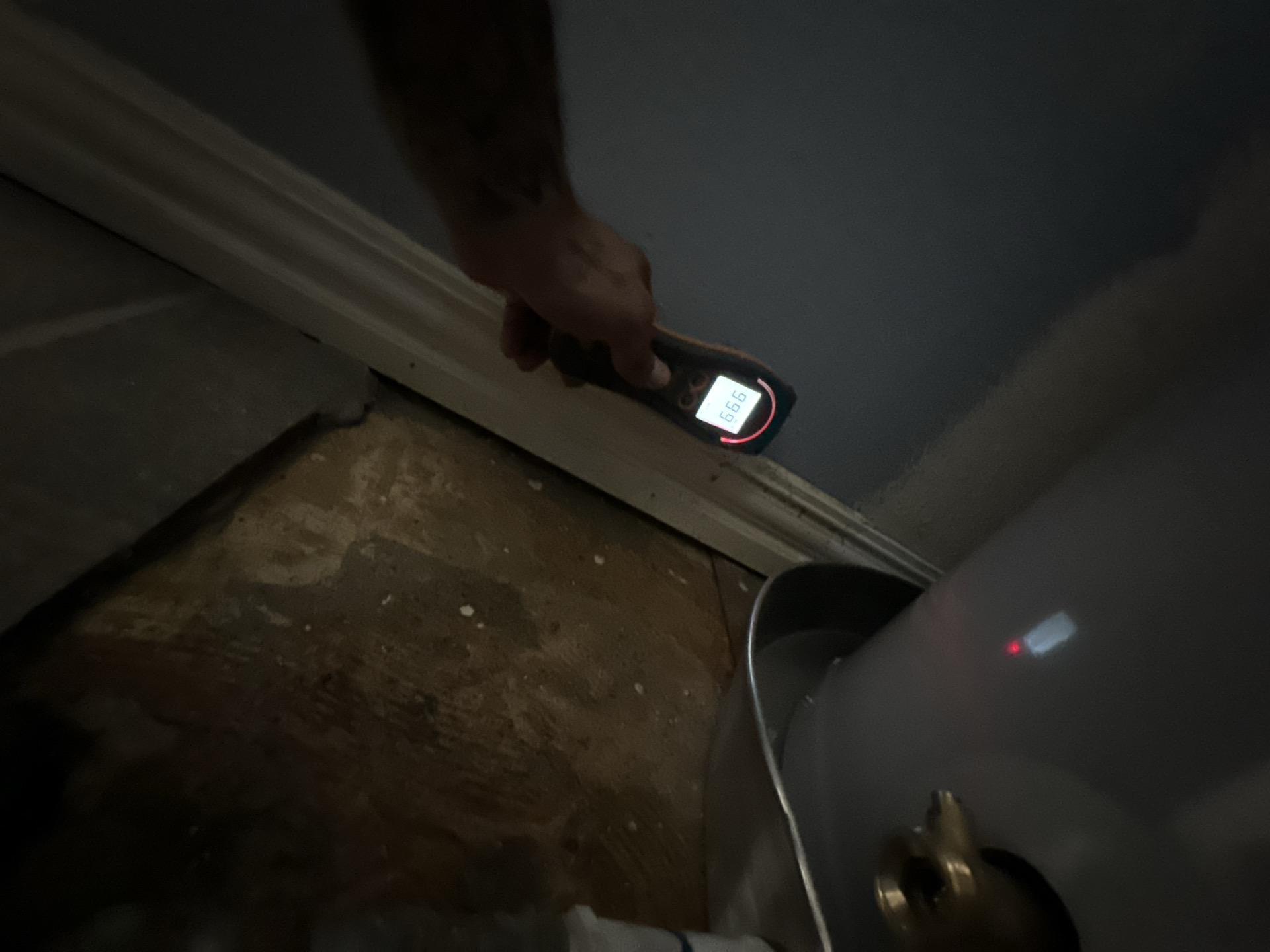 Moisture reading in the water heater closet showing elevated levels