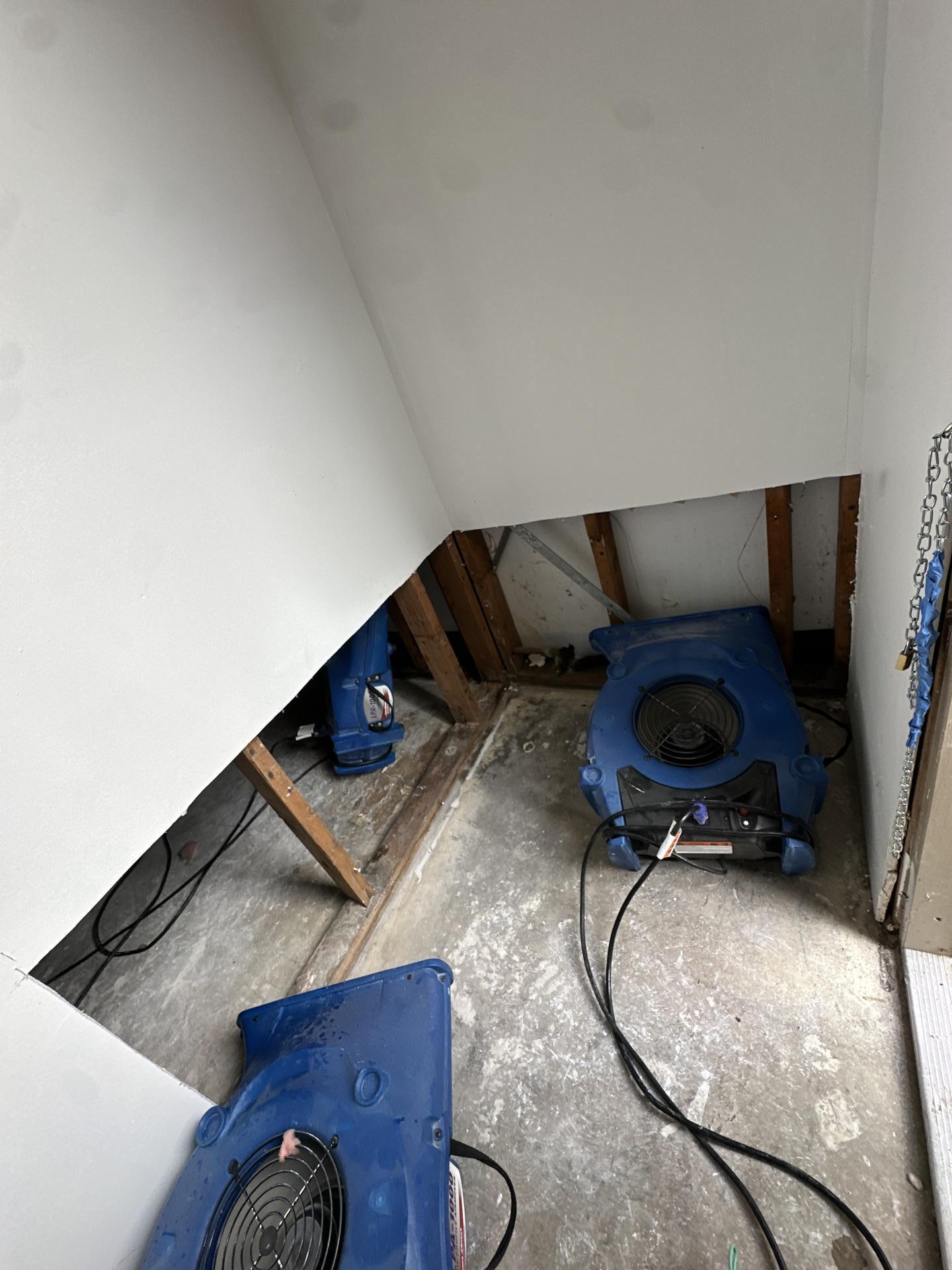 Air movers positioned to dry the exposed framing in the outside closet