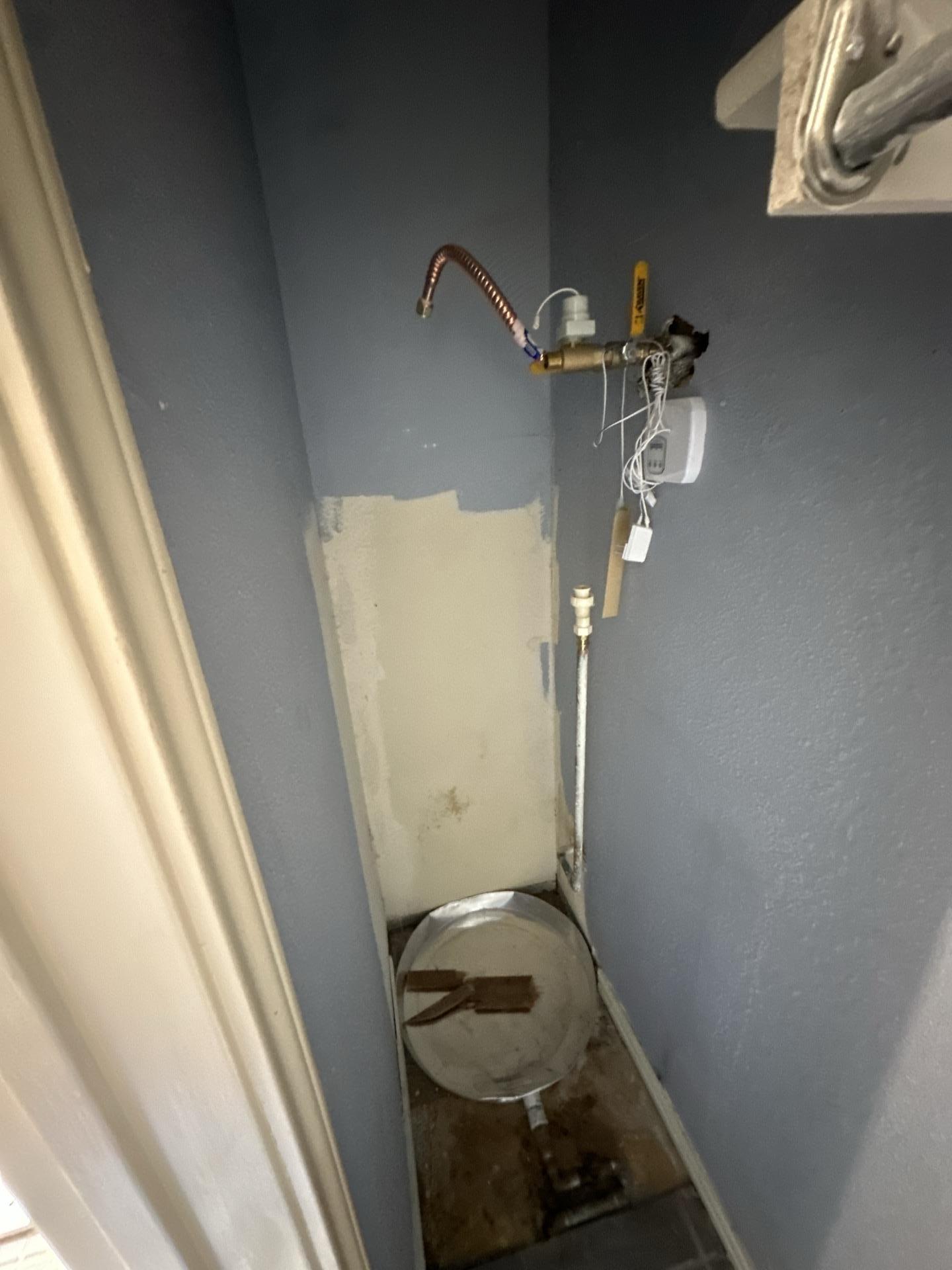 Failed water heater being removed after causing water damage