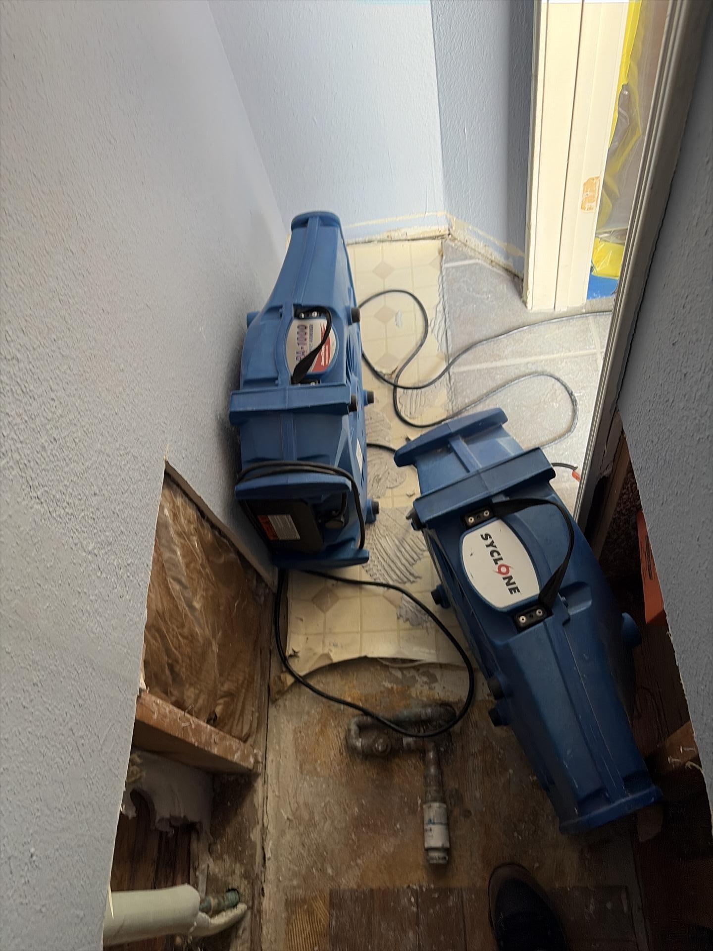Air movers drying the water heater room after extraction