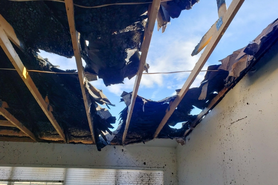 Charred ceiling and roof structure showing fire damage inside a Plano home before cleanup