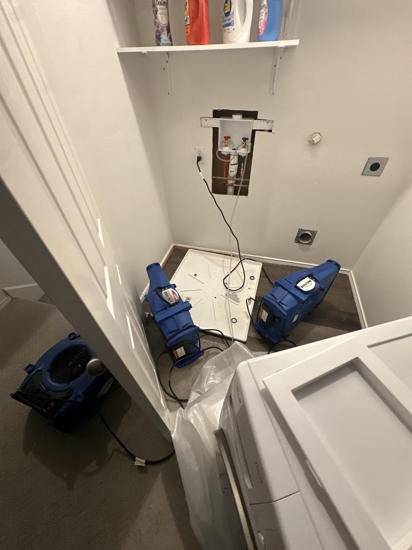 Continued drying process in the laundry room with restoration equipment