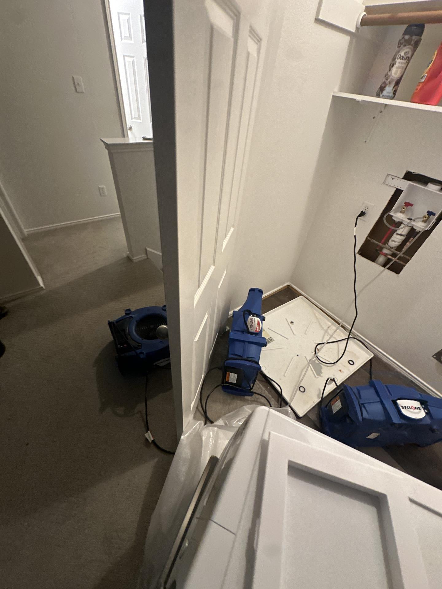 Drying equipment positioned in the laundry room during water mitigation