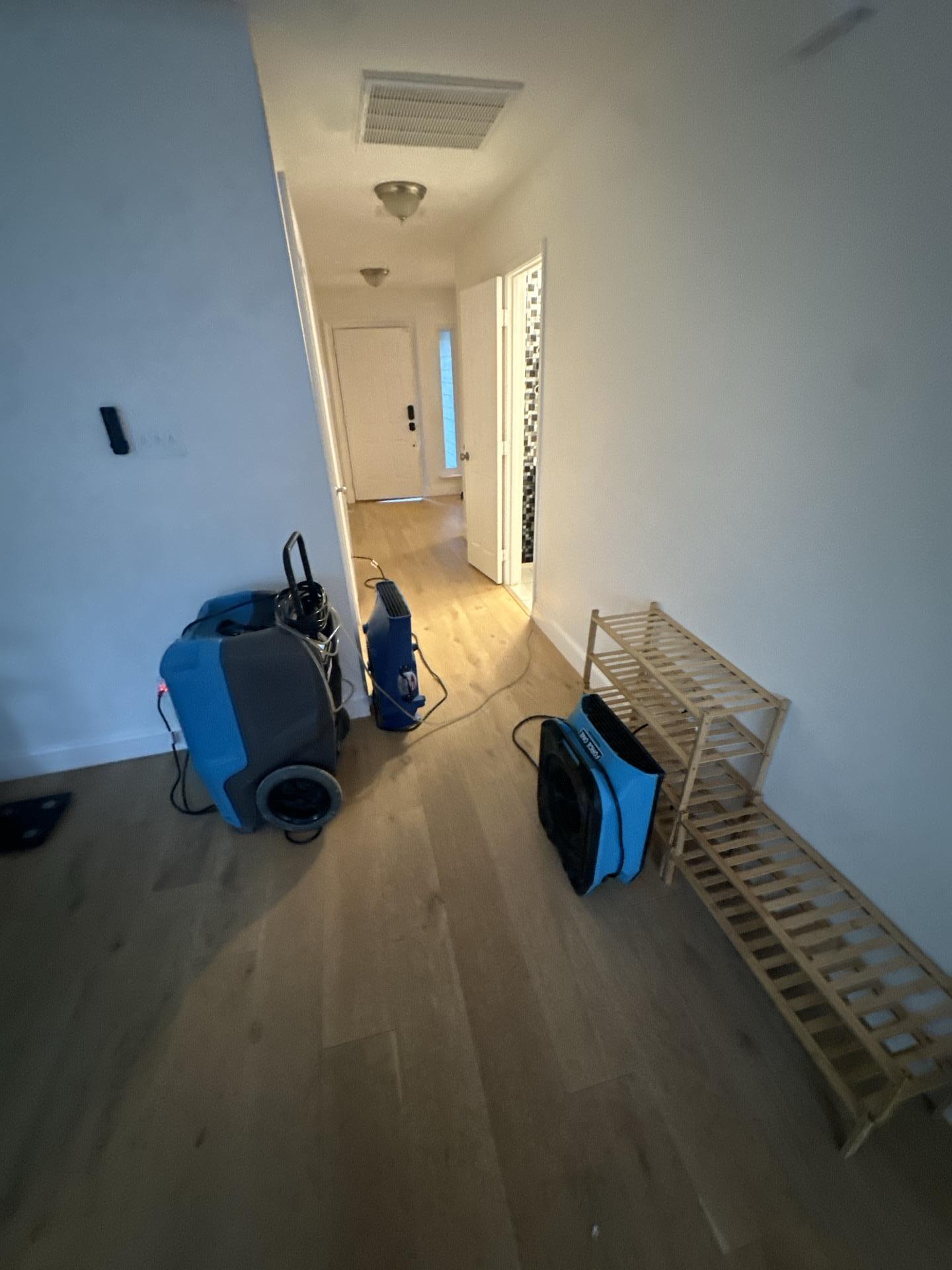 Drying process in the hallway after water traveled from the laundry room