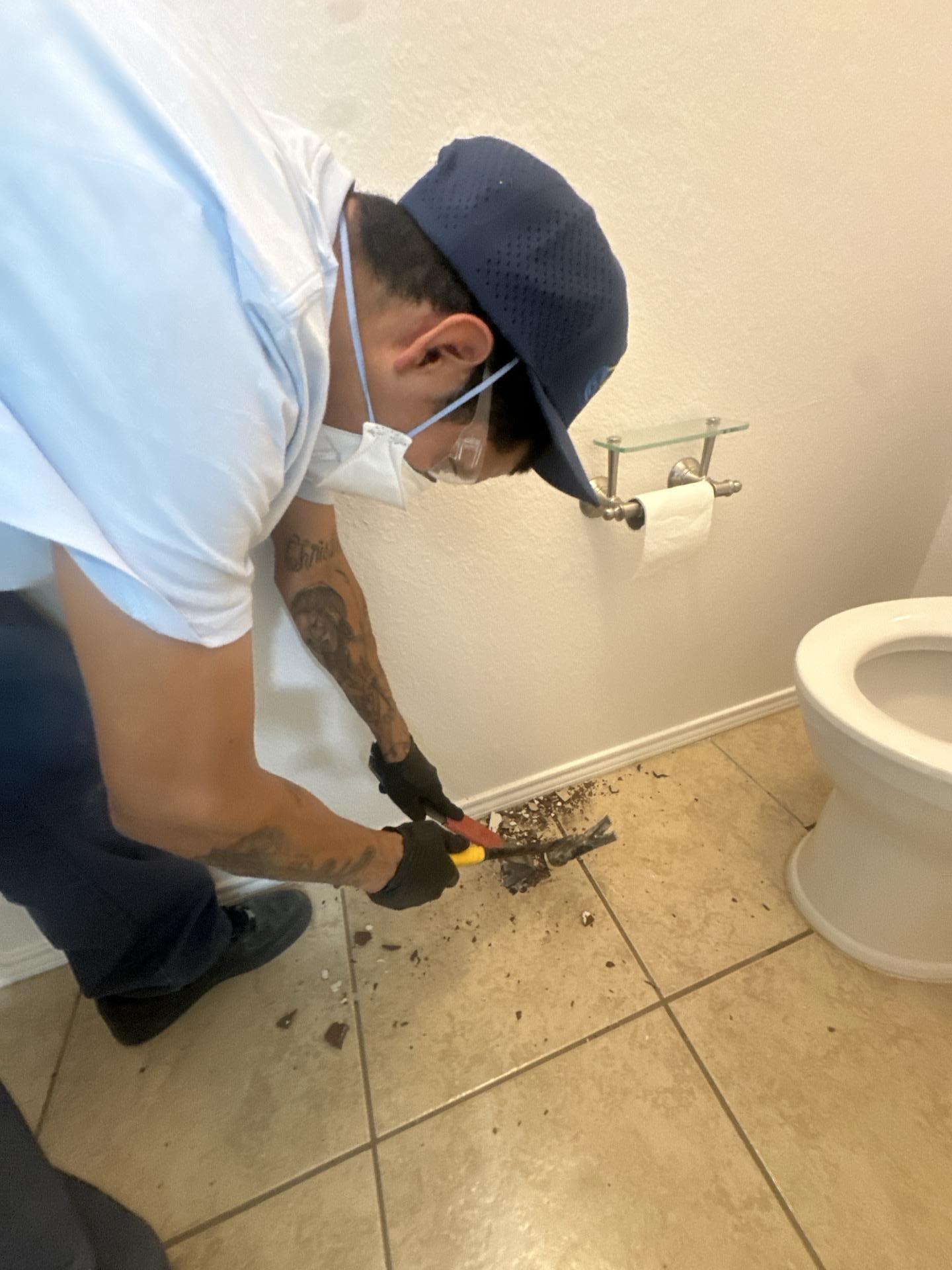Master bathroom demo work removing damaged flooring after the laundry room leak