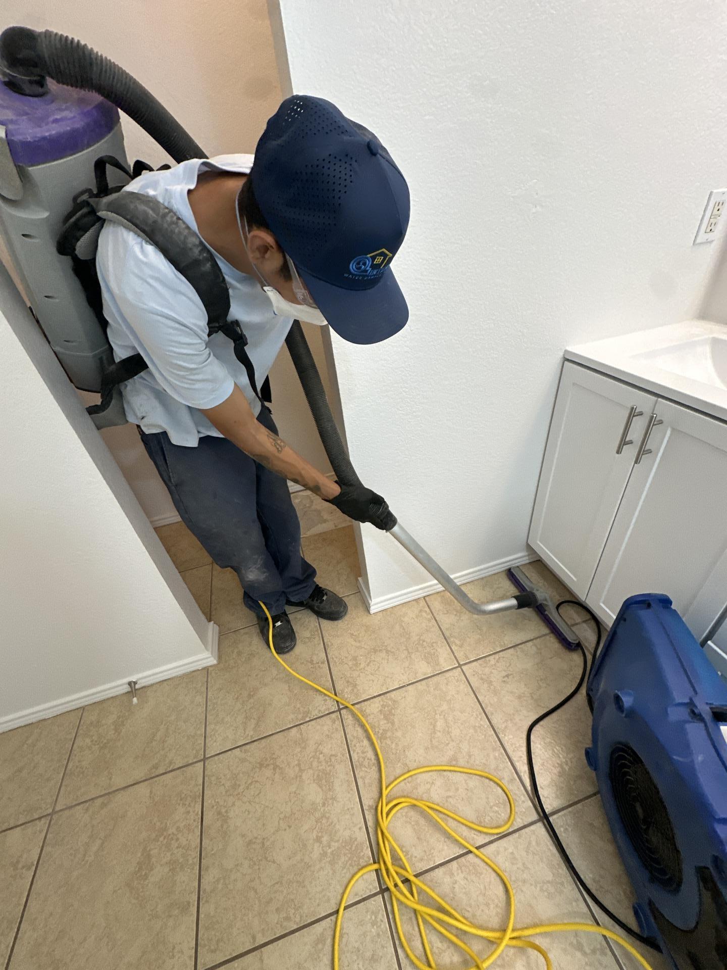 Master bathroom drying and HEPA vacuuming after the washing machine drain leak