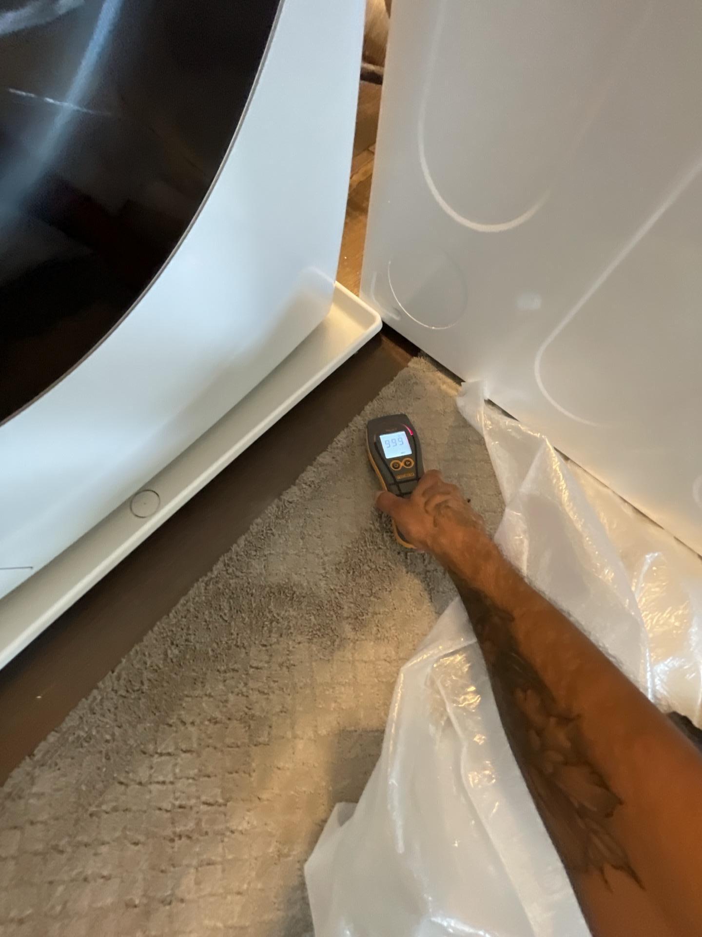 Moisture meter reading on a wall after a washing machine drain leak