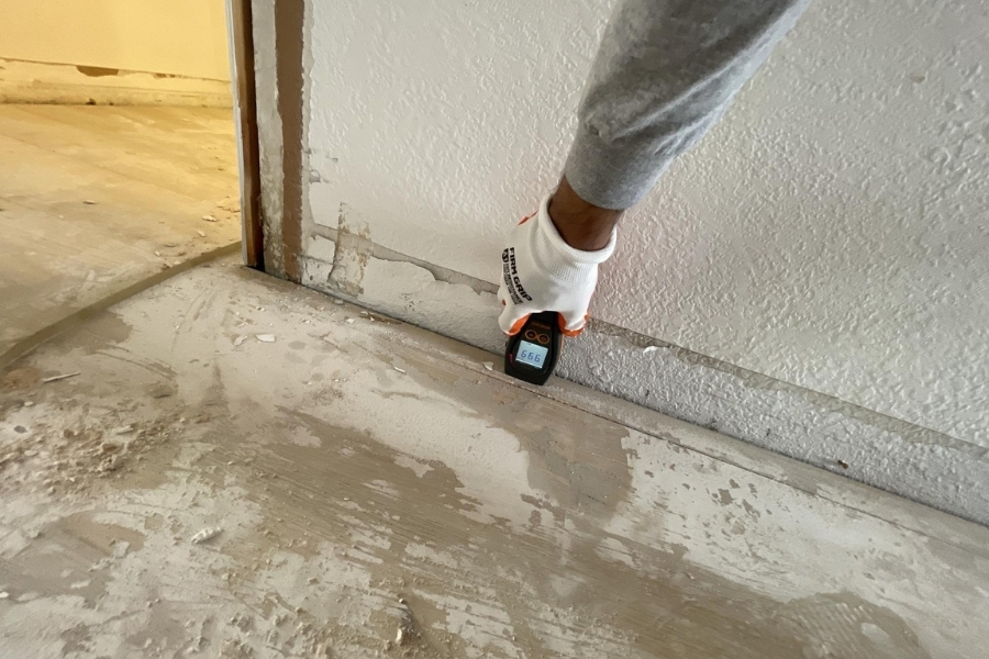 Baseboards and flooring removed from a Plano home where water damage left hidden moisture in the wall base and subfloor