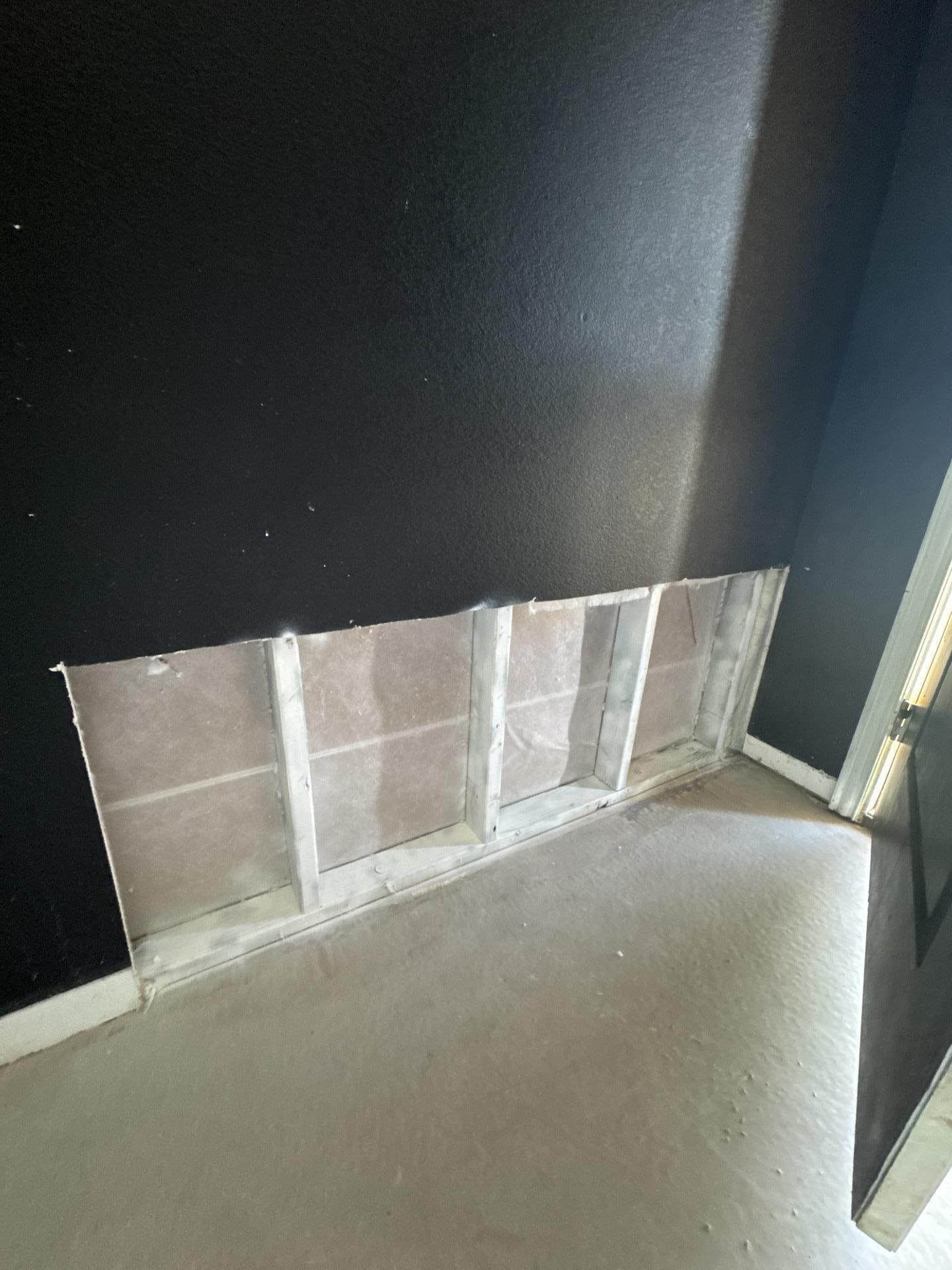 Home entryway after demo and mold remediation, cleaned down to the studs