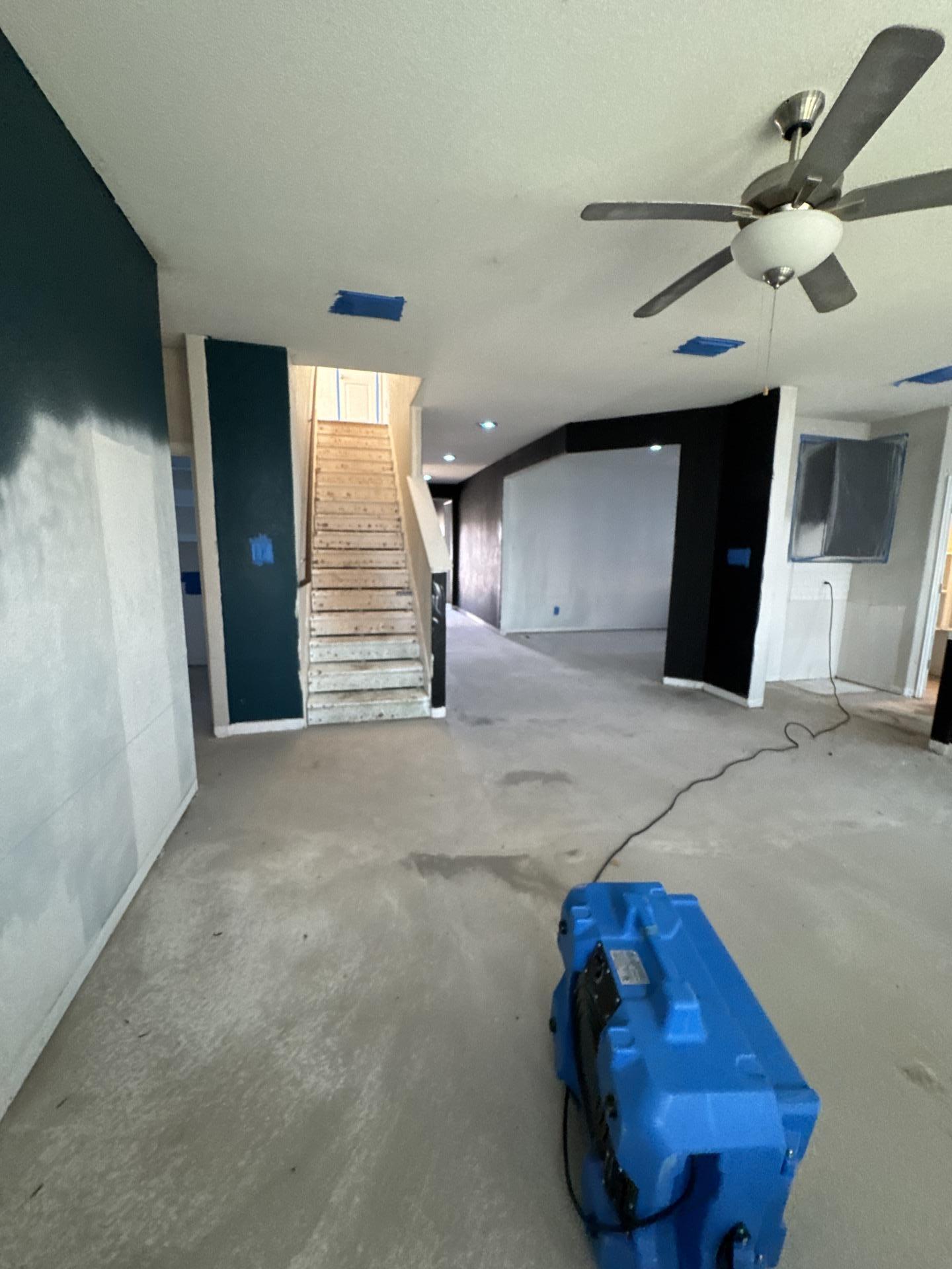 Air scrubber and containment setup in the living room during remediation