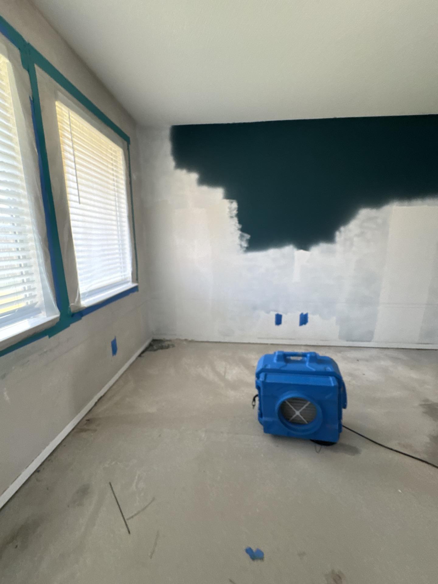 Living room set up with containment and a blue air scrubber running